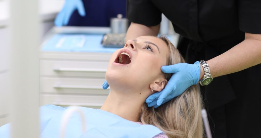 Dentist examining the Jaw for Jaw popping (jaw clicking) complaint